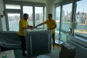 Movers carrying a sofa through a high-rise apartment