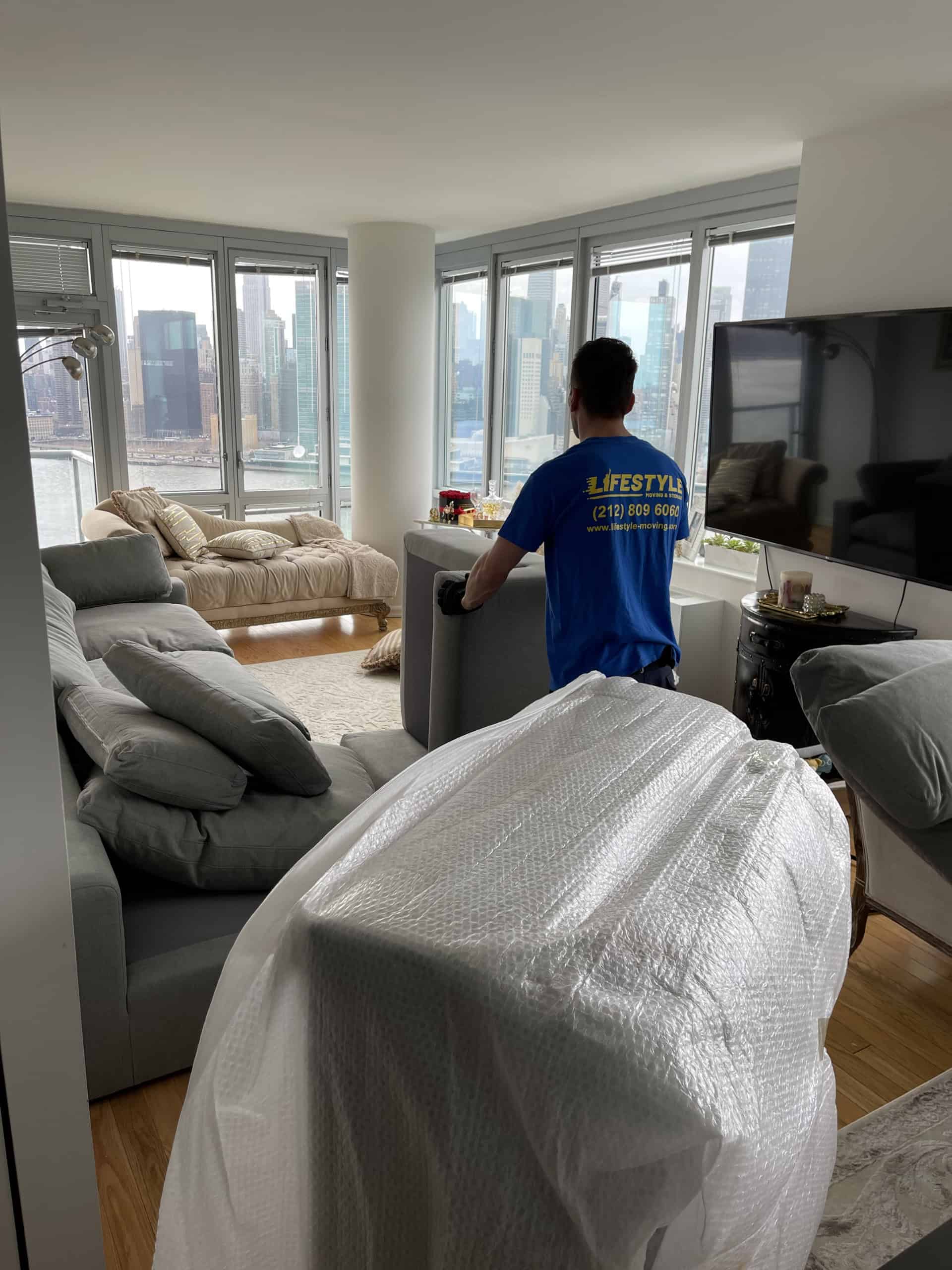 Mover protecting furniture inside a high-rise apartment