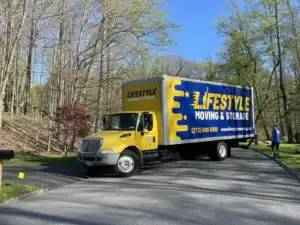 Lifestyle Moving & Storage truck parked on a wooded residential road