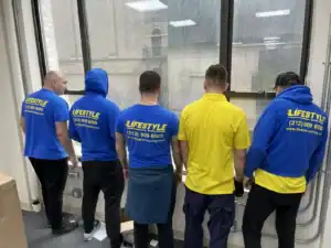 Moving crew posing together in a hallway