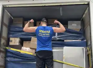 Mover arranging furniture inside a moving truck