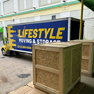 Wrapped furniture beside a Lifestyle Moving & Storage truck