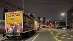 Lifestyle Moving & Storage truck on a city street at night