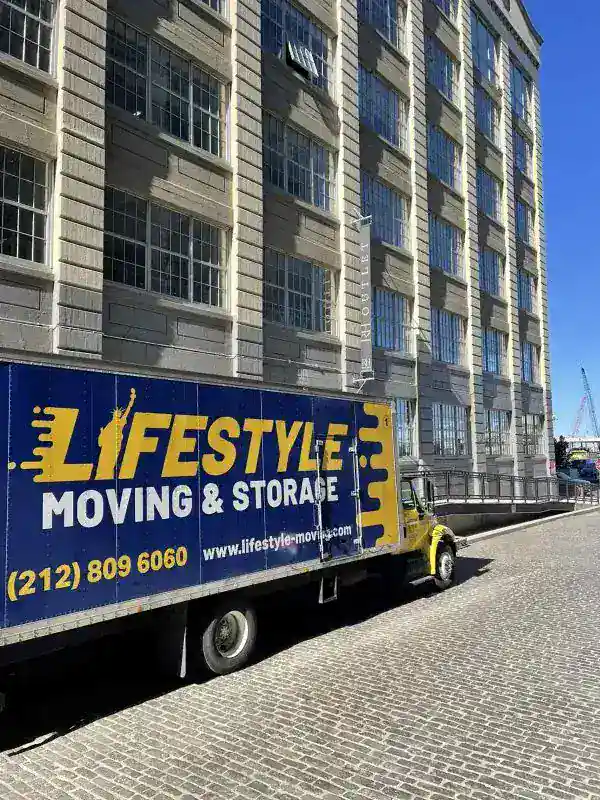 Lifestyle Moving & Storage truck parked beside a high-rise building